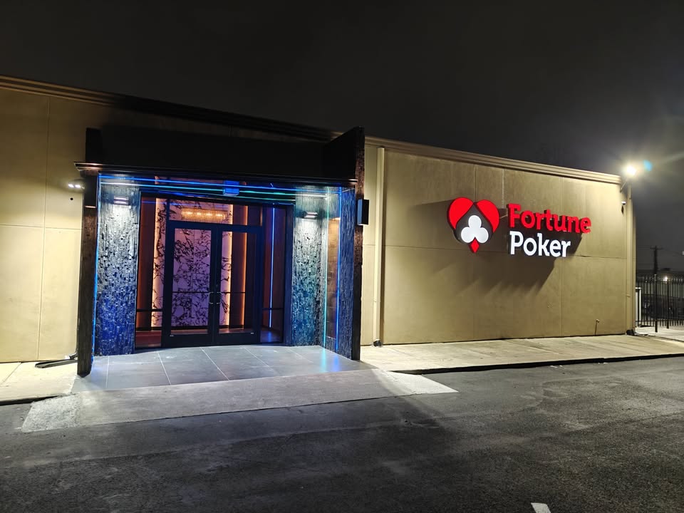 Fortune Poker lit waterfall entrance at night